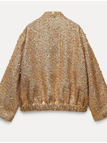 "Veste bomber femme dorée, moderne et ajustée, détails côtelés, idéale pour soirées et occasions spéciales."