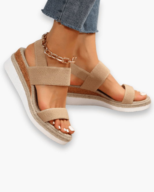 Sandales compensées élégantes pour femme, semelle haute et bride élastique, style chic idéal pour tenues estivales.