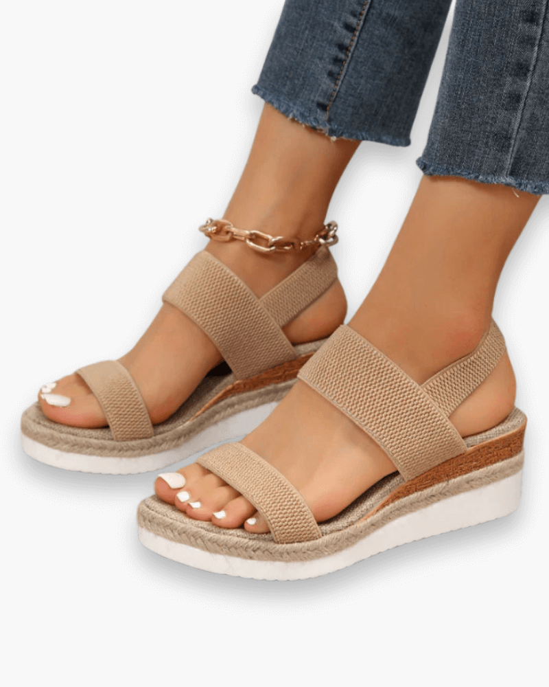 Sandales compensées élégantes pour femme, semelle haute et bride élastique, style chic idéal pour tenues estivales.