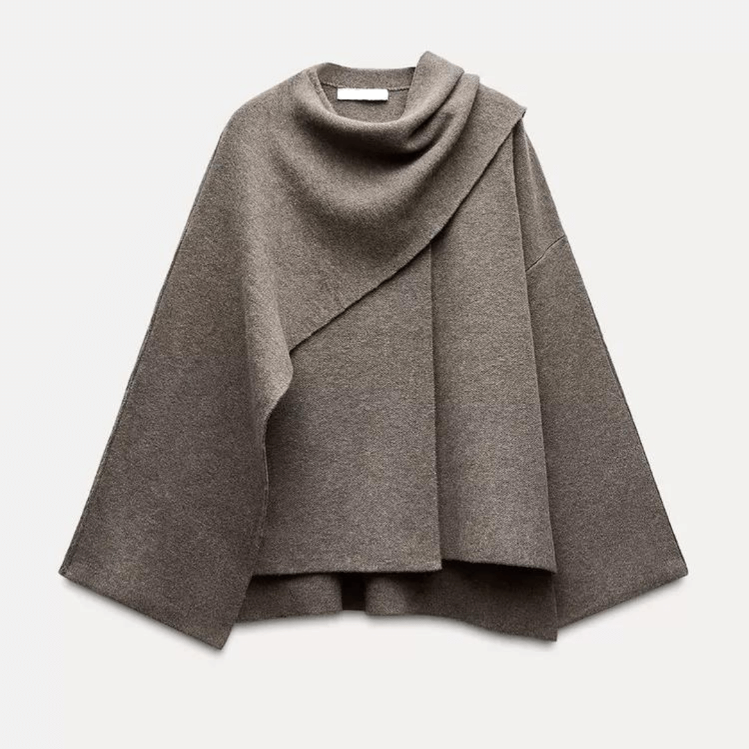 "Manteau cape femme chic automne, design asymétrique gris, tissu doux, style moderne et confortable pour temps frais."