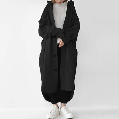 "Trench coat long femme Julina avec capuche, coupe ample et poches latérales, élégance chic pour un look décontracté."