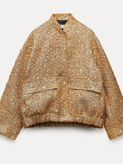 "Veste bomber femme dorée, moderne et ajustée, détails côtelés, idéale pour soirées et occasions spéciales."