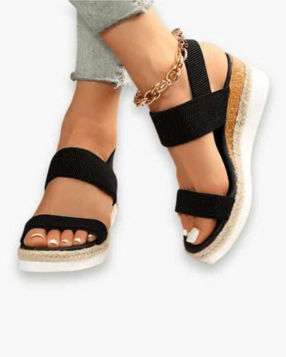 Sandales compensées élégantes pour femme, semelle haute et bride élastique, style chic idéal pour tenues estivales.